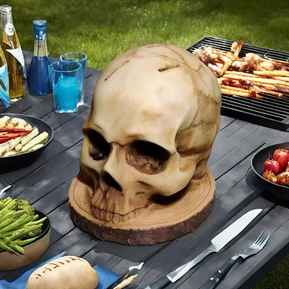 A decorative wooden skull sculpture displayed on a dark table with kitchen utensils and bottles.