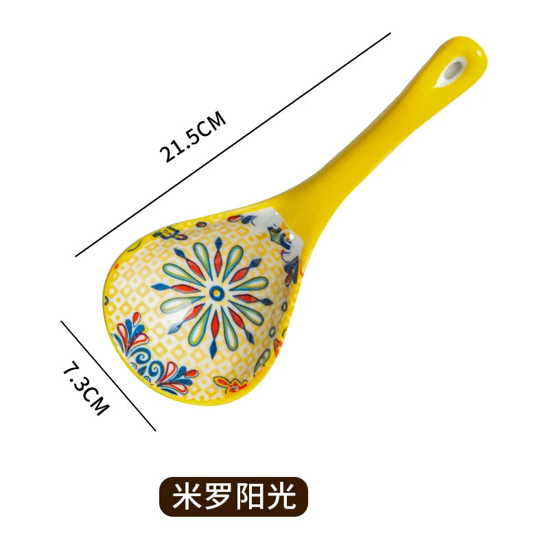 Yellow ceramic ladle with floral pattern, measuring 21.5cm long and 7.3cm wide.
