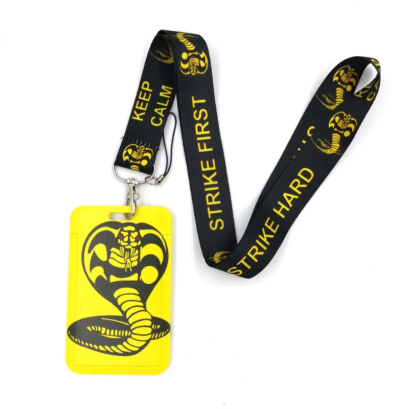 Black snake patterned lanyard with 'KEEP CALM STRIKE FIRST STRIKE HARD' text attached to a yellow card holder.