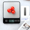 A black digital kitchen scale displays a reading of 45 grams next to fresh red tomatoes and battery information.