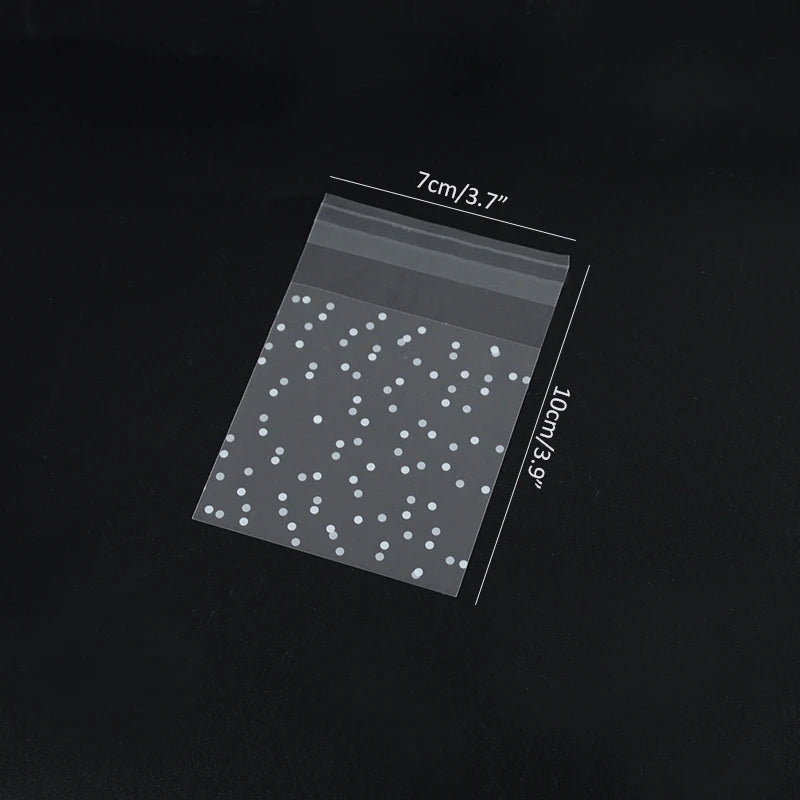 A transparent cookie bag filled with small white dots, showing the size dimensions 7cm/3.7" by 10cm/3.9".