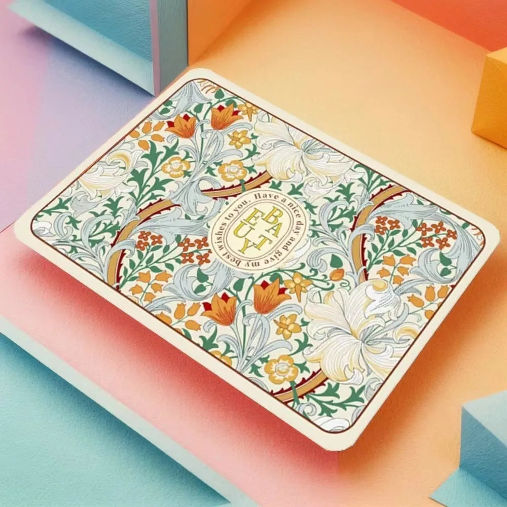 A rectangular absorbent dish drying mat with a floral pattern is displayed on an orange background.