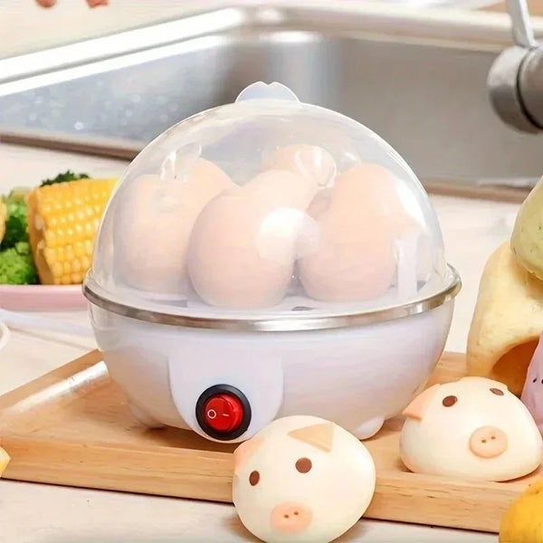 A white compact electric steamer containing several boiled eggs on a wooden cutting board.