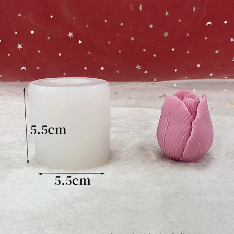 A white silicone flower candle mold next to a pink silicone flower, set against a red background.