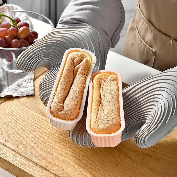Set Silikon-Mini-Backformen, hellorange und weiß, auf einer Holzoberfläche.
