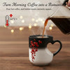 A black mug with a heart design is pouring hot coffee into a white cup, creating steam and a romantic atmosphere.