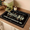 A black mat with gold lettering for a coffee bar featuring the text Coffee Hot Chocolate Tea