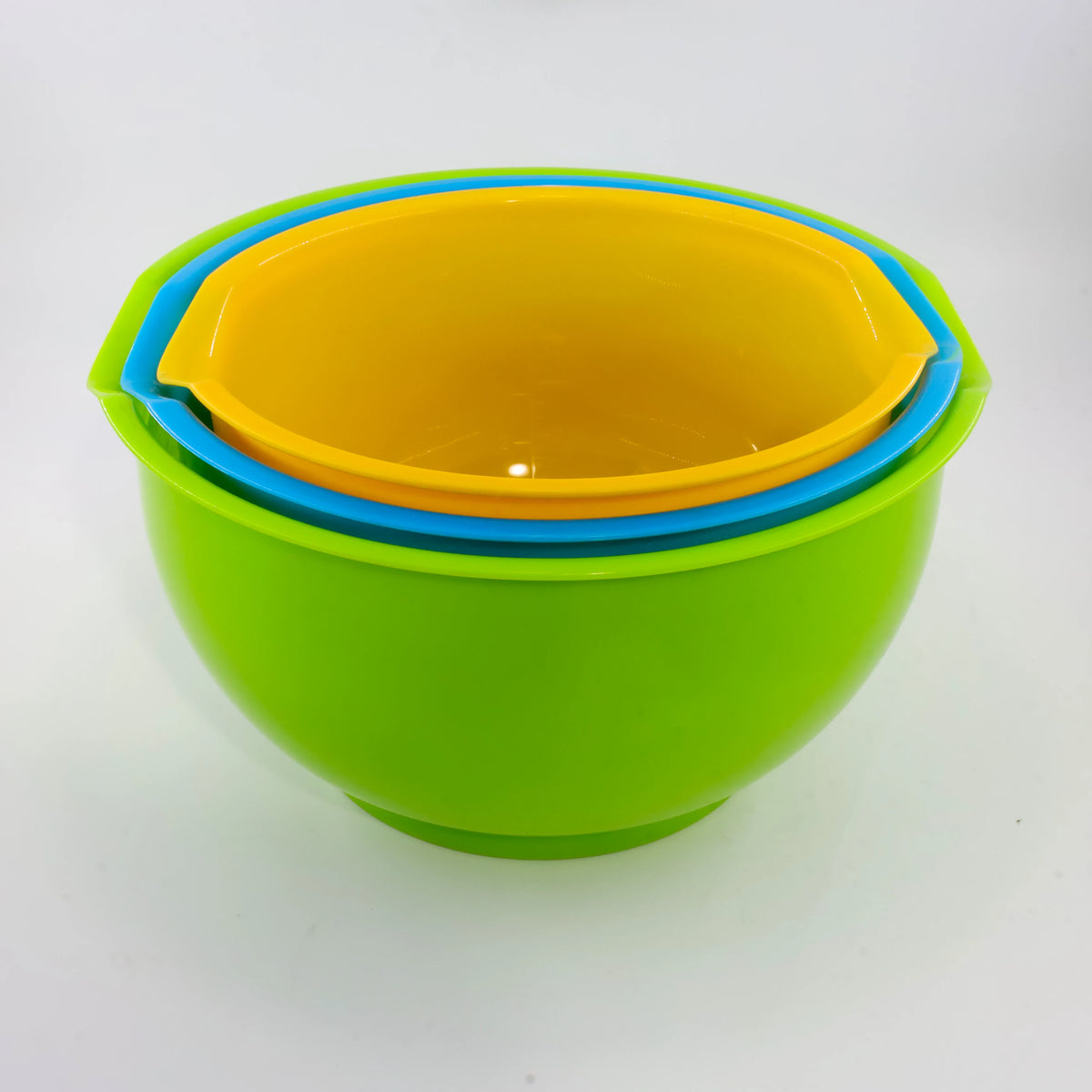 A stack of three multi-sized plastic bowls in green, orange, and blue.
