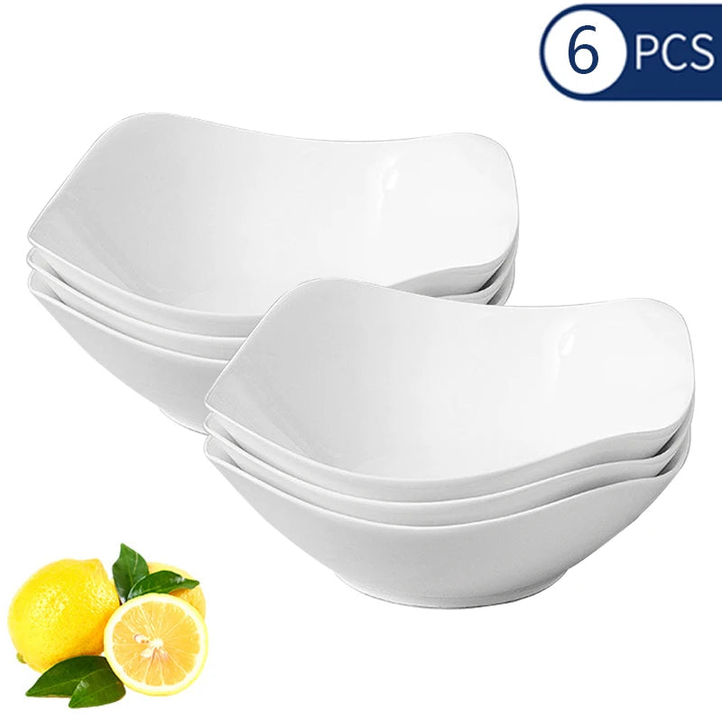A set of six white reusable PP salad bowls is shown with a lemon for scale.