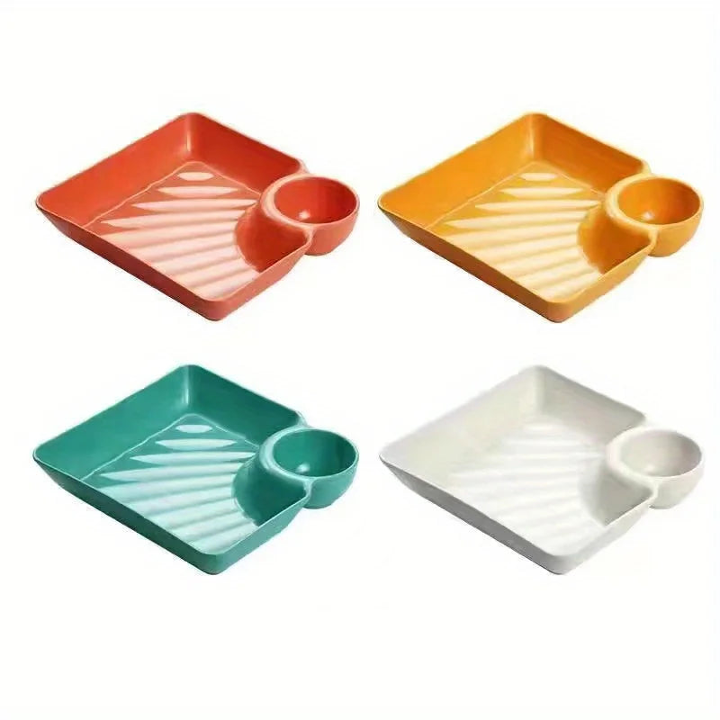 Three serving plates in orange, yellow, and white with accompanying dipping bowls.