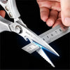 A hand holds professional stainless steel kitchen shears with a blue glow, showing the blades and markings.