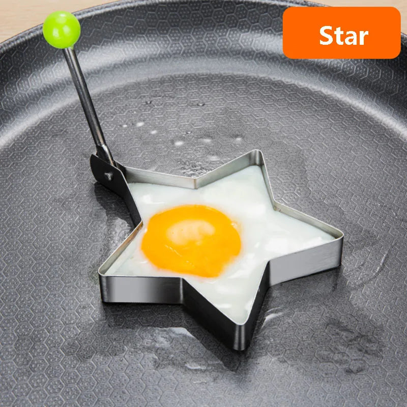 Stainless steel star-shaped mold for frying an egg placed on a dark plate.