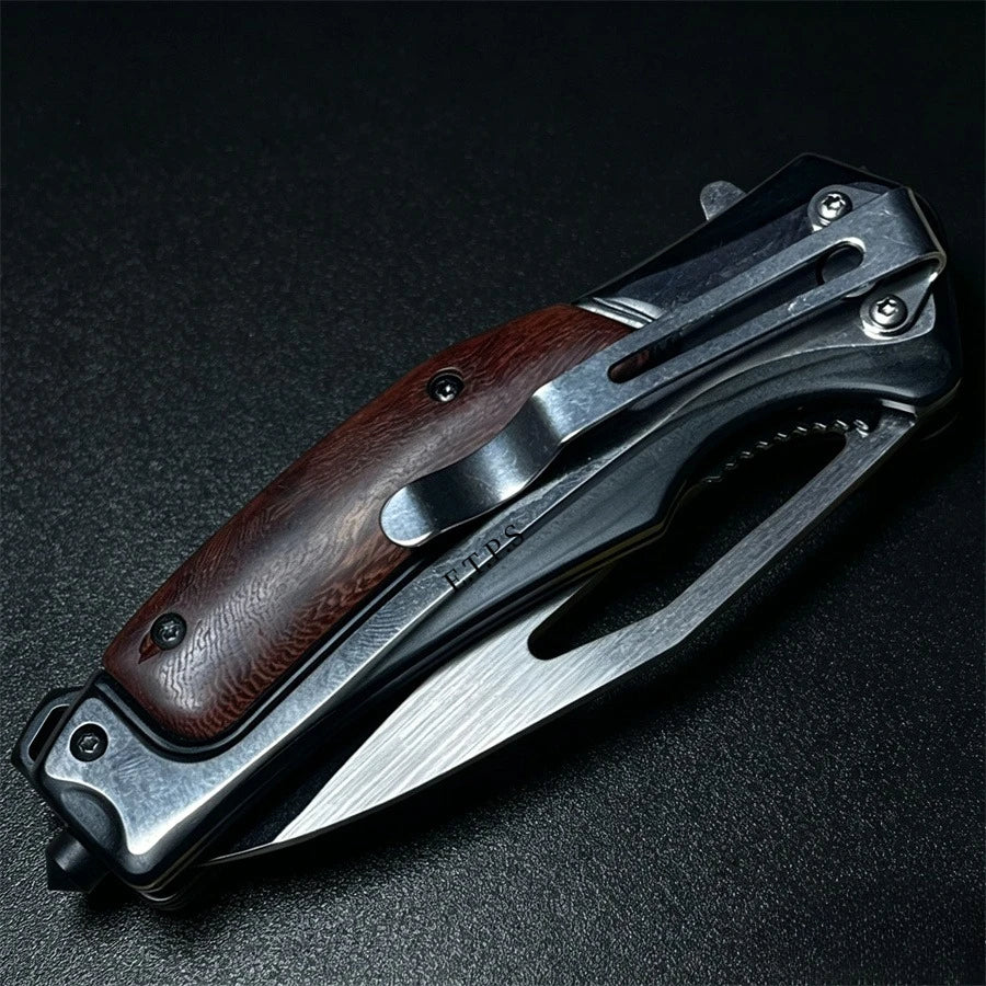 A folding knife with a dark wood handle and a silver steel blade is shown against a black background.