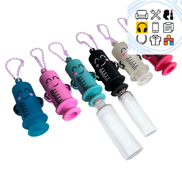 A set of syringe-shaped medication openers in various colors and designs, including pink, blue, black, and white.