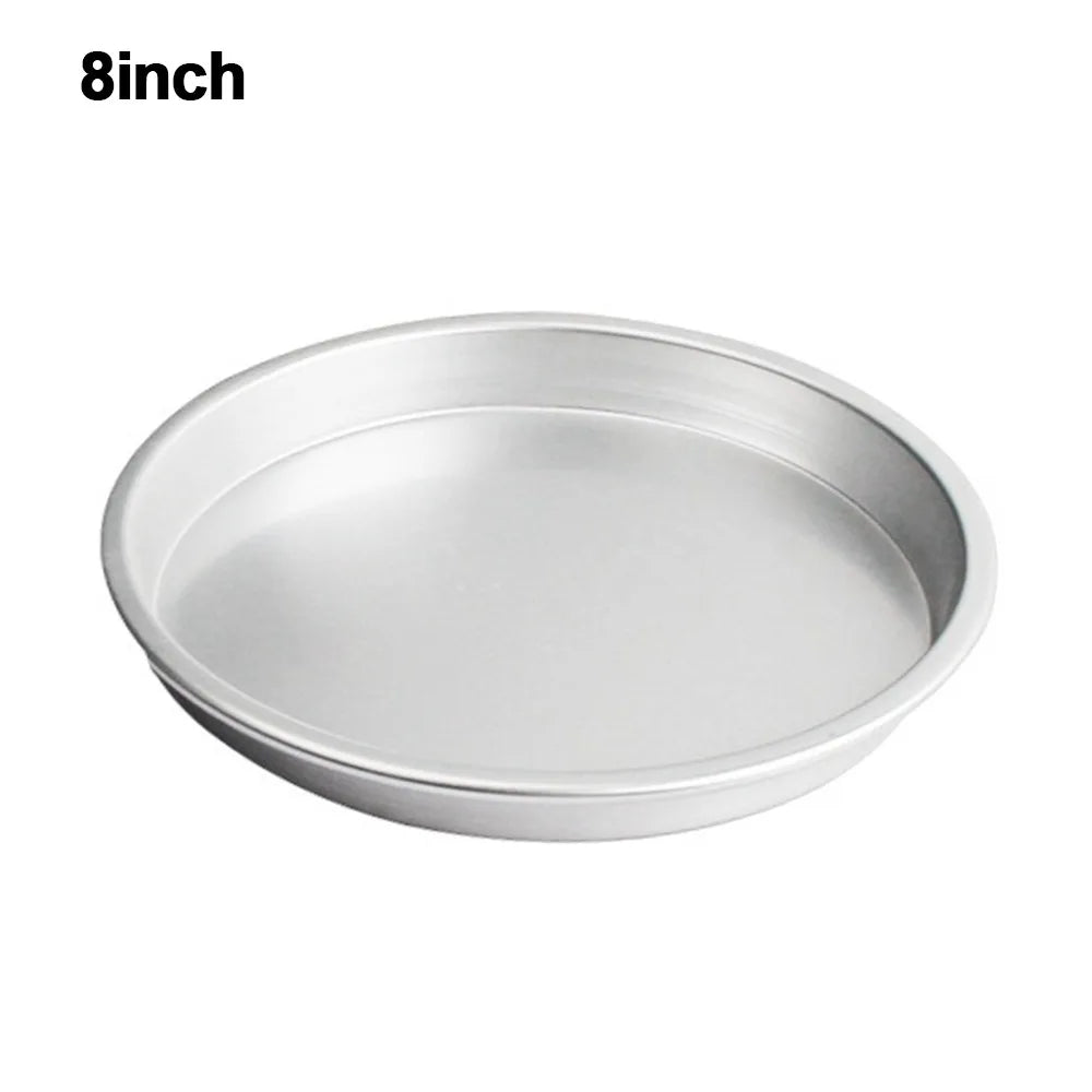 A round, silver non-stick pizza baking pan with a perforated bottom.