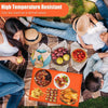 A family enjoying a meal on an orange silicone BBQ baking mat outdoors.