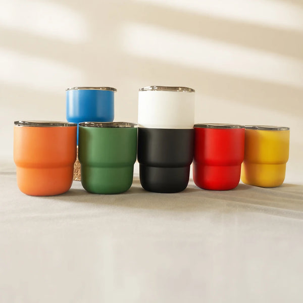 A row of five 304 stainless steel insulated tumblers in various colors including blue, white, green, black, red, and yellow.