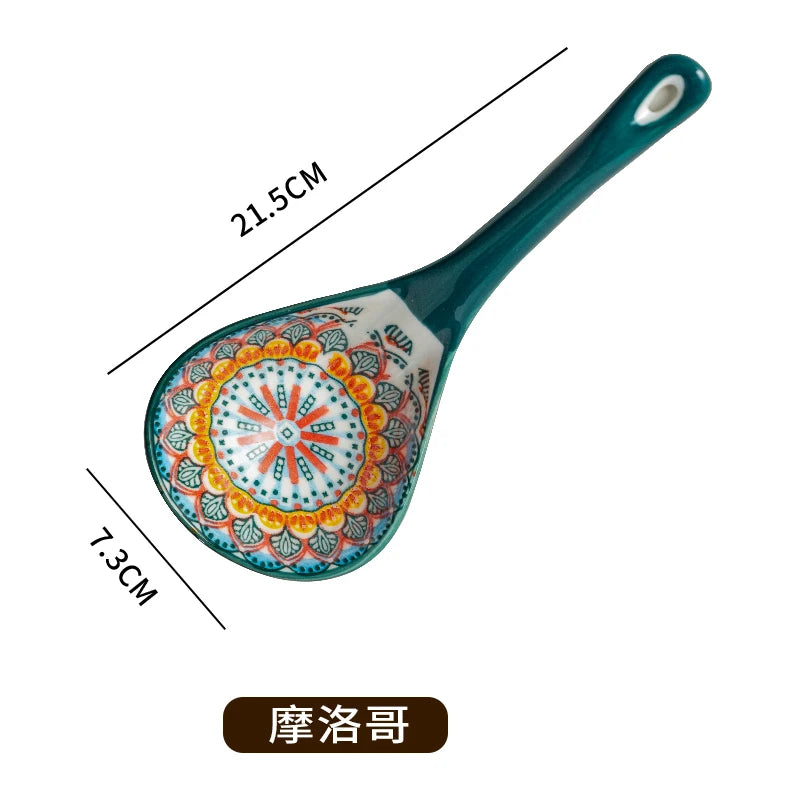 A teal ceramic ladle with an intricate floral pattern, shown with dimension lines.