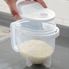 A hand is holding a white plastic rice washing sieve and strainer over a clear container filled with white rice.