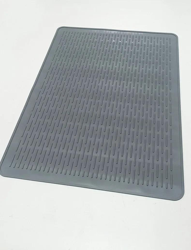 A gray silicone induction cooker protector mat with a textured, ribbed surface.