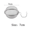 Silver stainless steel tea infuser sphere with a chain for hanging, measuring 7cm in diameter.