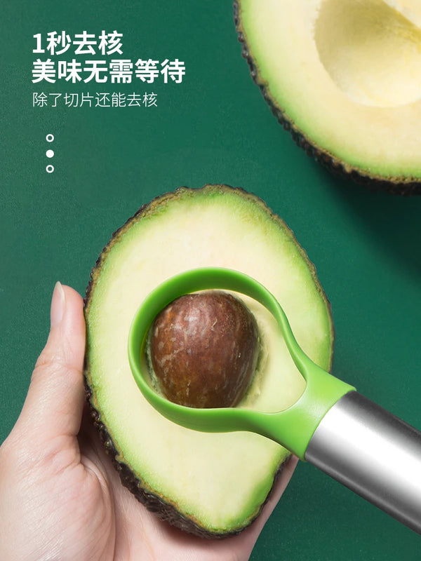 A hand holds a stainless steel avocado cutter slicing an avocado half, demonstrating how to easily remove the pit.