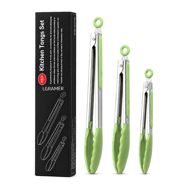 A set of three stainless steel kitchen tongs with green silicone grips displayed in a black box.
