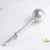 Silver telescopic ball tea infuser with a long metal rod and perforated sphere.