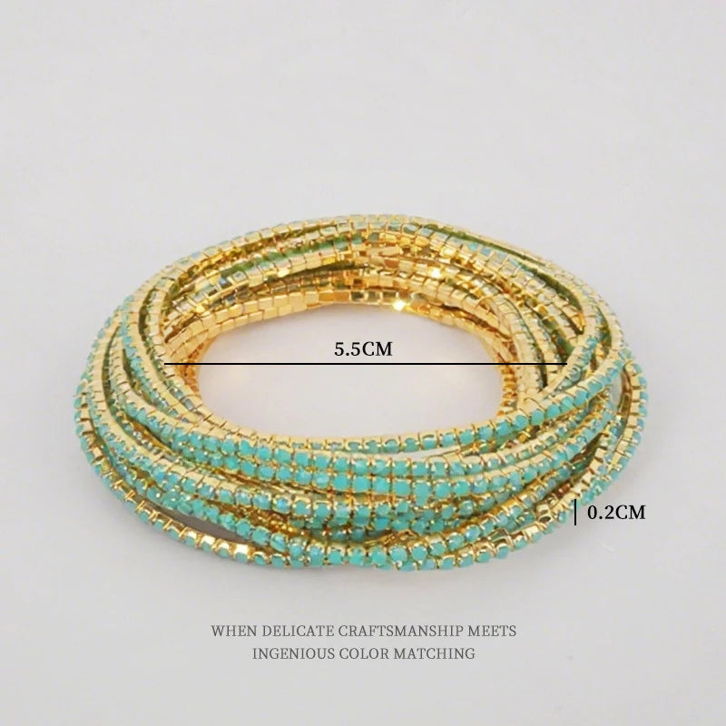 Gold and turquoise acrylic elastic bracelets stacked on a white background.