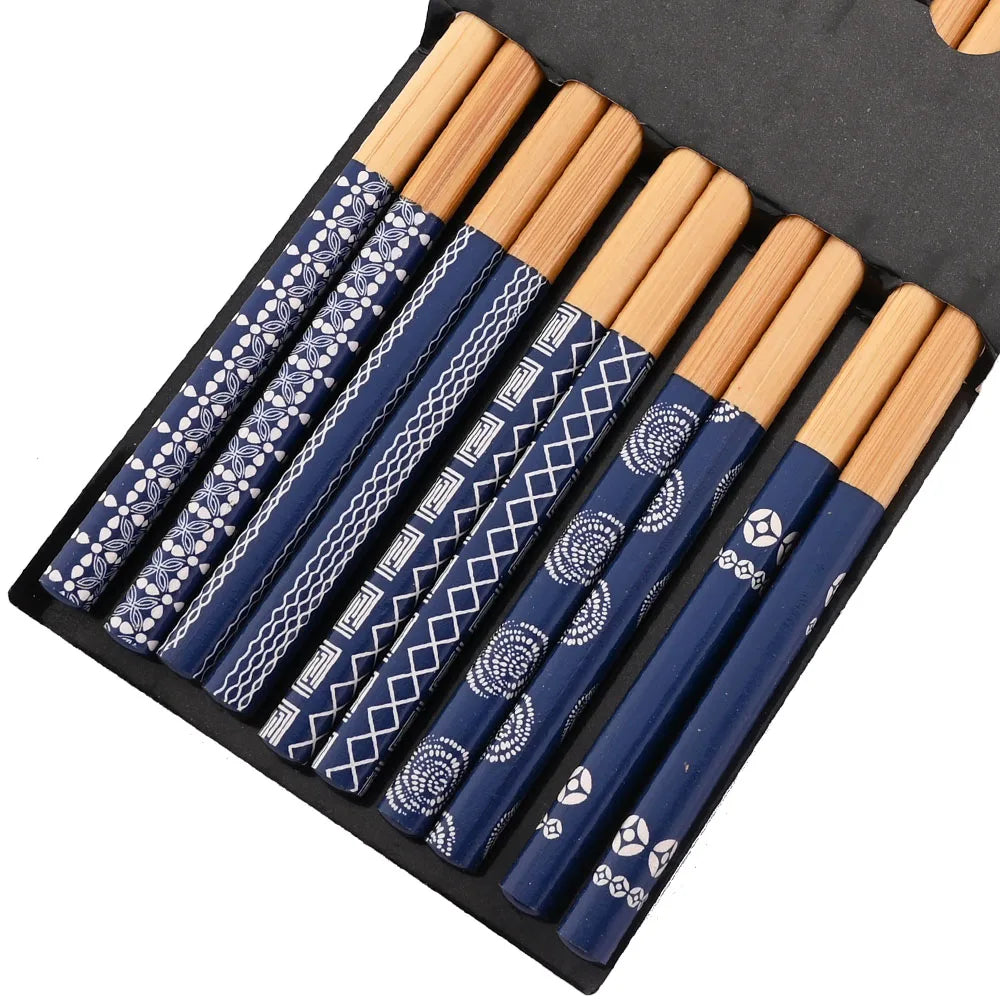 A set of reusable bamboo chopsticks with blue and white patterned tips stored in a black case.