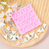 Pink silicone alphabet cake decoration molds with various letter shapes scattered on a wooden board