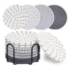 A set of eight round absorbent cotton drink coasters in various shades of gray and white.