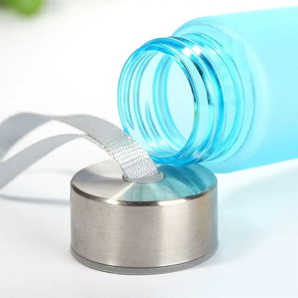 A clear blue plastic bottle with a ribbed cap is shown next to a metal bottle opener.