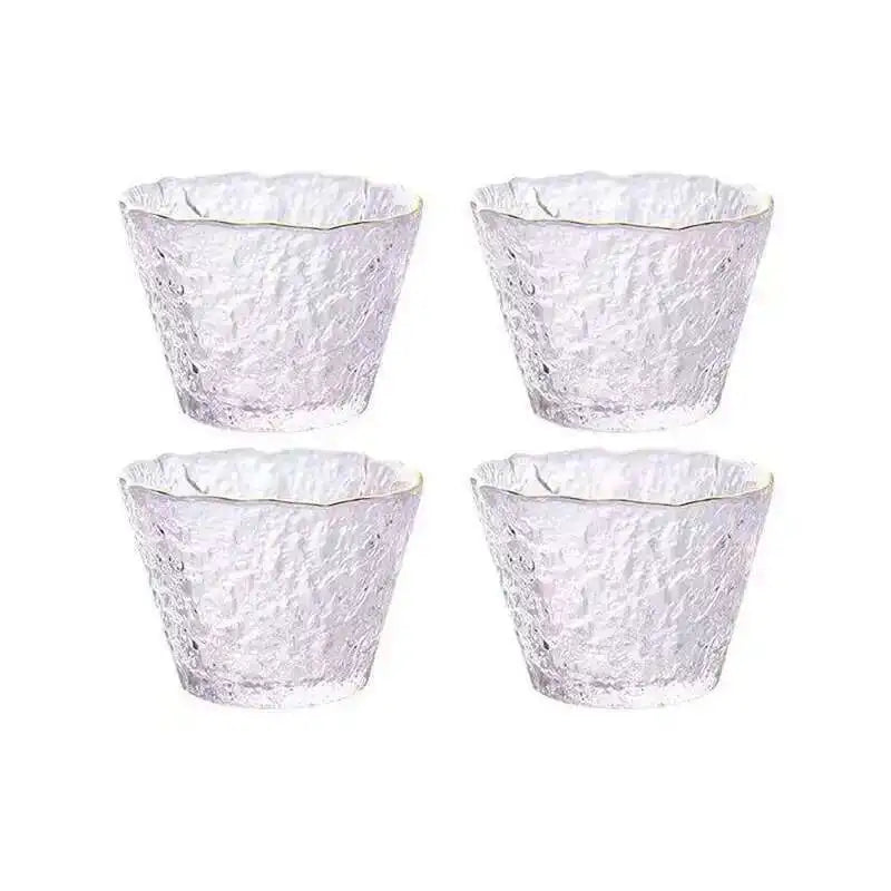 Four textured clear glass tea cups or bowls arranged in a square pattern.