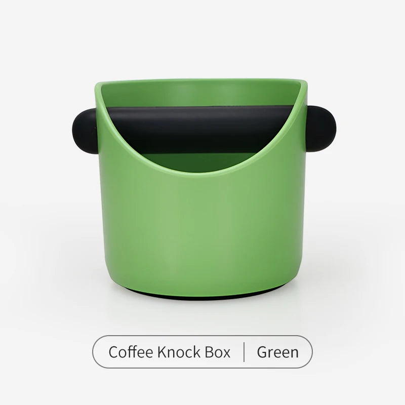 A green coffee knock box with a black lid shown from above.