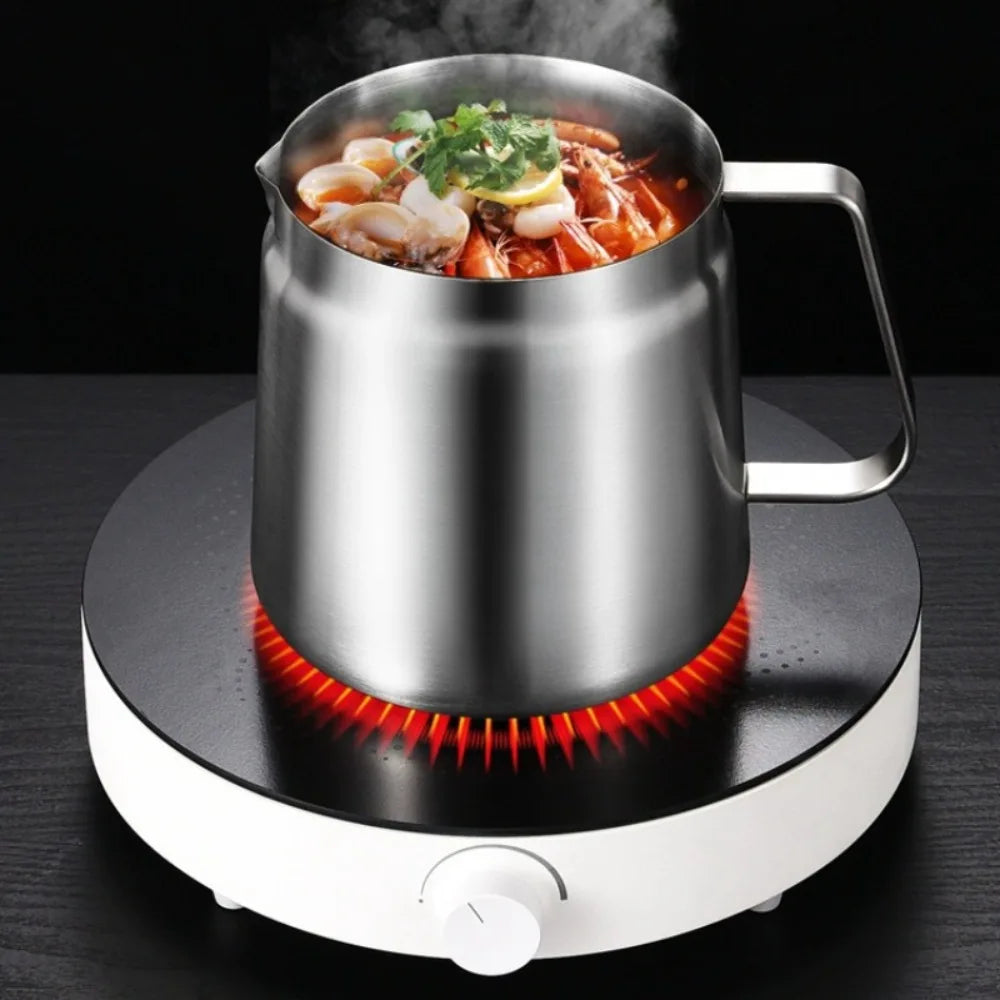 A stainless steel deep fryer pot is heating food on a circular electric heating plate.