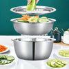 A three-piece stainless steel mixing bowl set with a strainer, grater, and a separate bowl, shown with fresh vegetables.