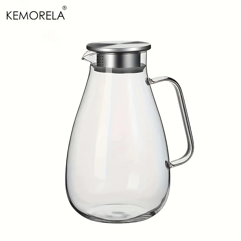 A clear glass pitcher with a metal lid and handle used for beverages.