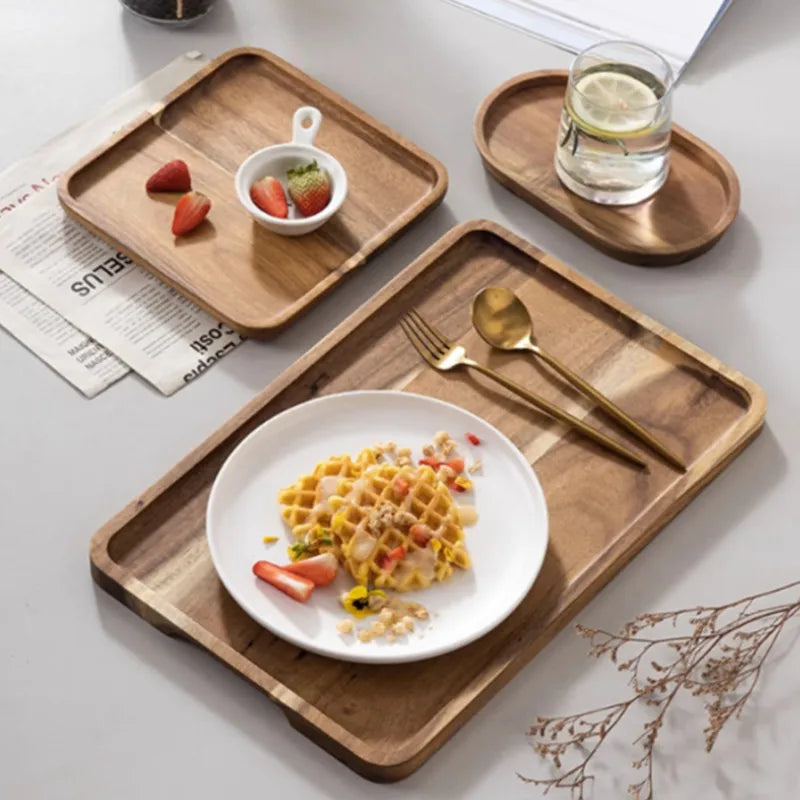 A wooden serving tray holds a plate of breakfast food and a glass of water on a light gray surface.
