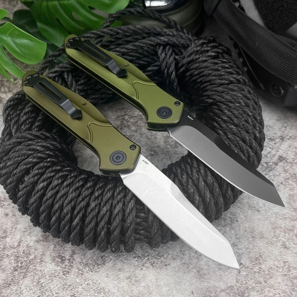 A folding pocket knife with a green handle and silver blade is coiled in black rope.
