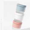 A stack of five food-grade ice molds in pastel colors, including light blue, white, and pink.