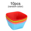 A stack of ten random colored reusable silicone cupcake liners in various shades of red, green, and blue.