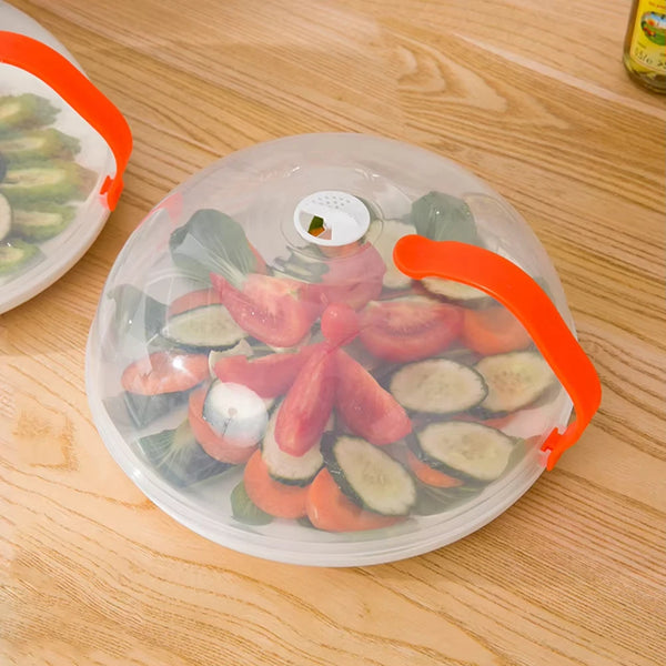 A clear plastic container with an orange lid holds sliced vegetables like tomatoes and cucumbers on a wooden surface.