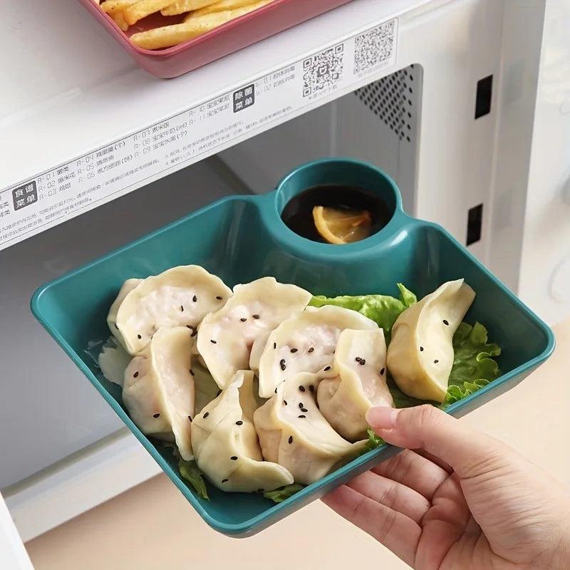 A hand holds a teal serving plate filled with steamed dumplings and lettuce leaves.