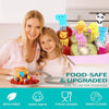 A woman and a child are shown with a colorful food-safe set of cartoon animal fruit picks on a plate.