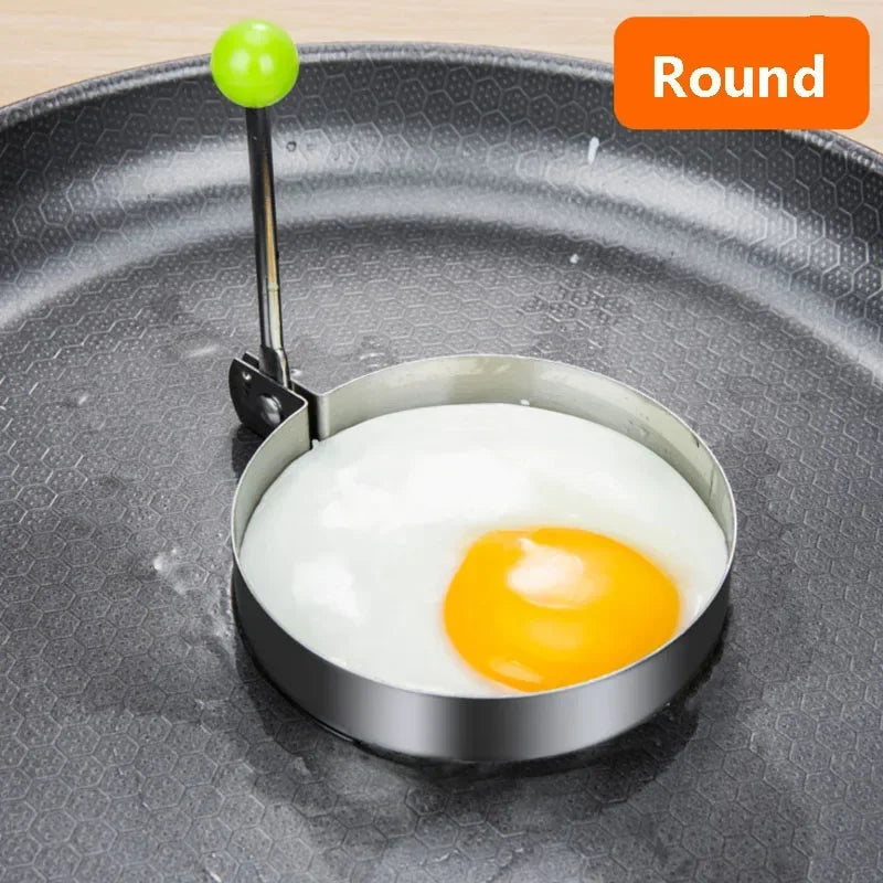 A round stainless steel mold holding a fried egg on a dark plate.
