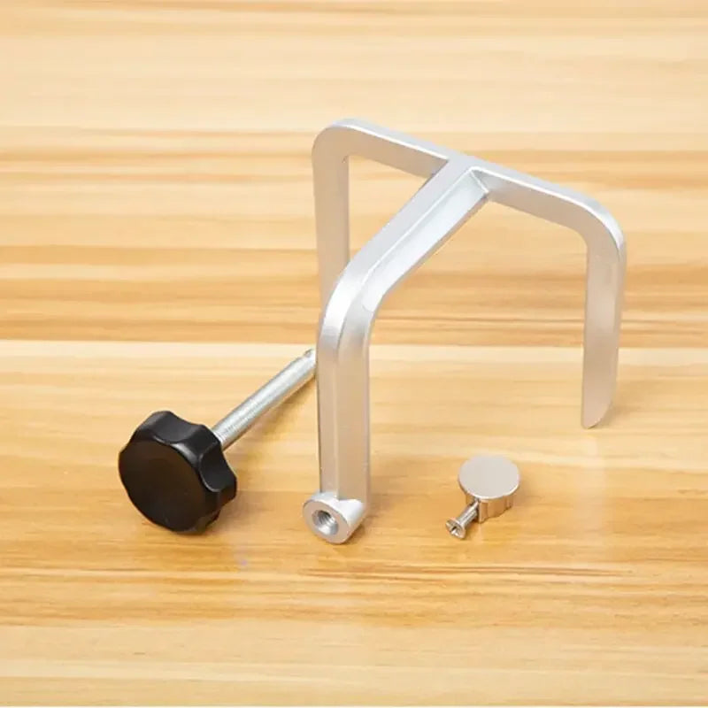 A silver diamond knife sharpener set consisting of a handle and a sharpening block resting on a wooden surface.