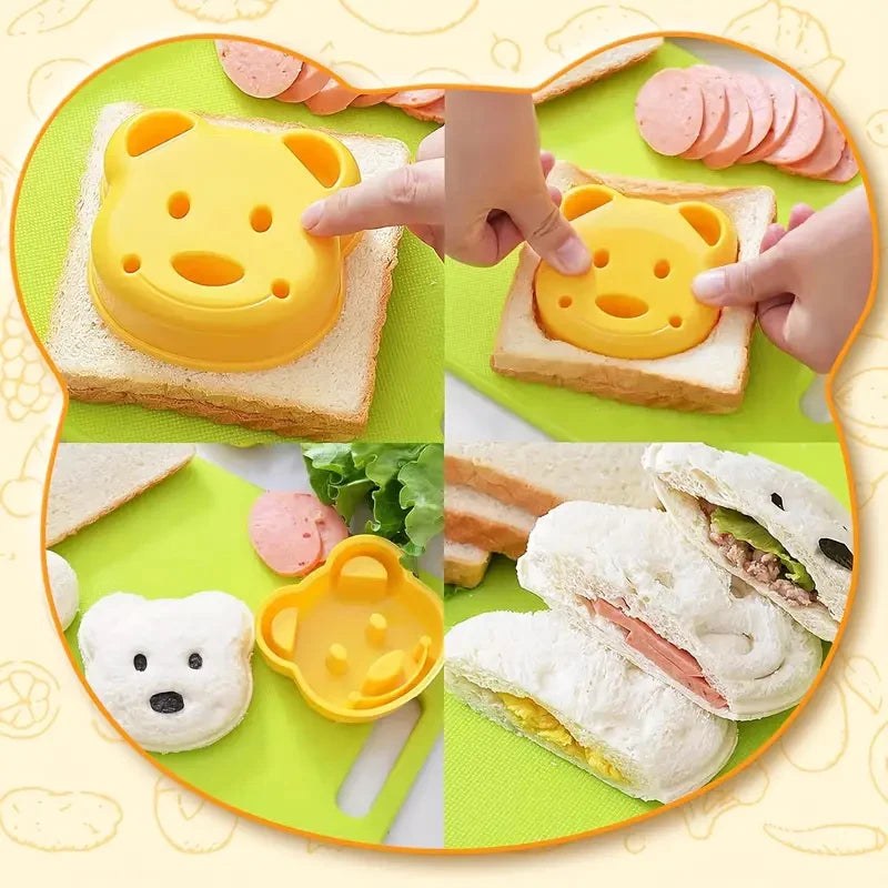 A set of yellow plastic fruit and cake cutters used for cutting food items like bread and sandwiches.