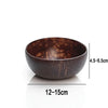 A dark brown coconut shell serving bowl with visible natural texture and dimensions of 4.5-6.5cm in height and 12-15cm in dia