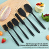 A set of six black silicone kitchen tools for baking and prep including spatulas and a brush